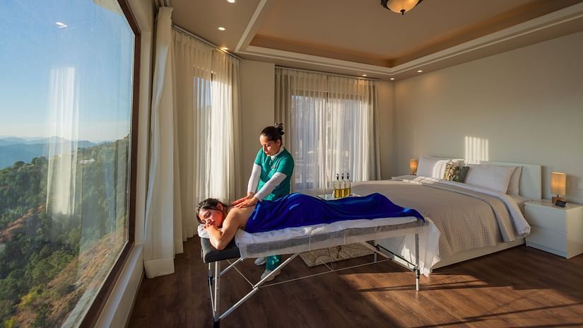 The Manor Shimla - A masseuse massaging a guest in our hotel room