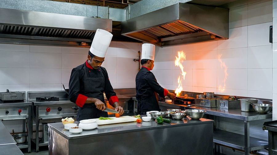 two chefs preparing a meal in the kitchen