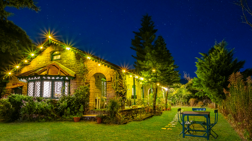 Night view of cottage with a lawn surrounded by trees at The Ramgarh Bungalows - 19th Century, Above Nainital.
