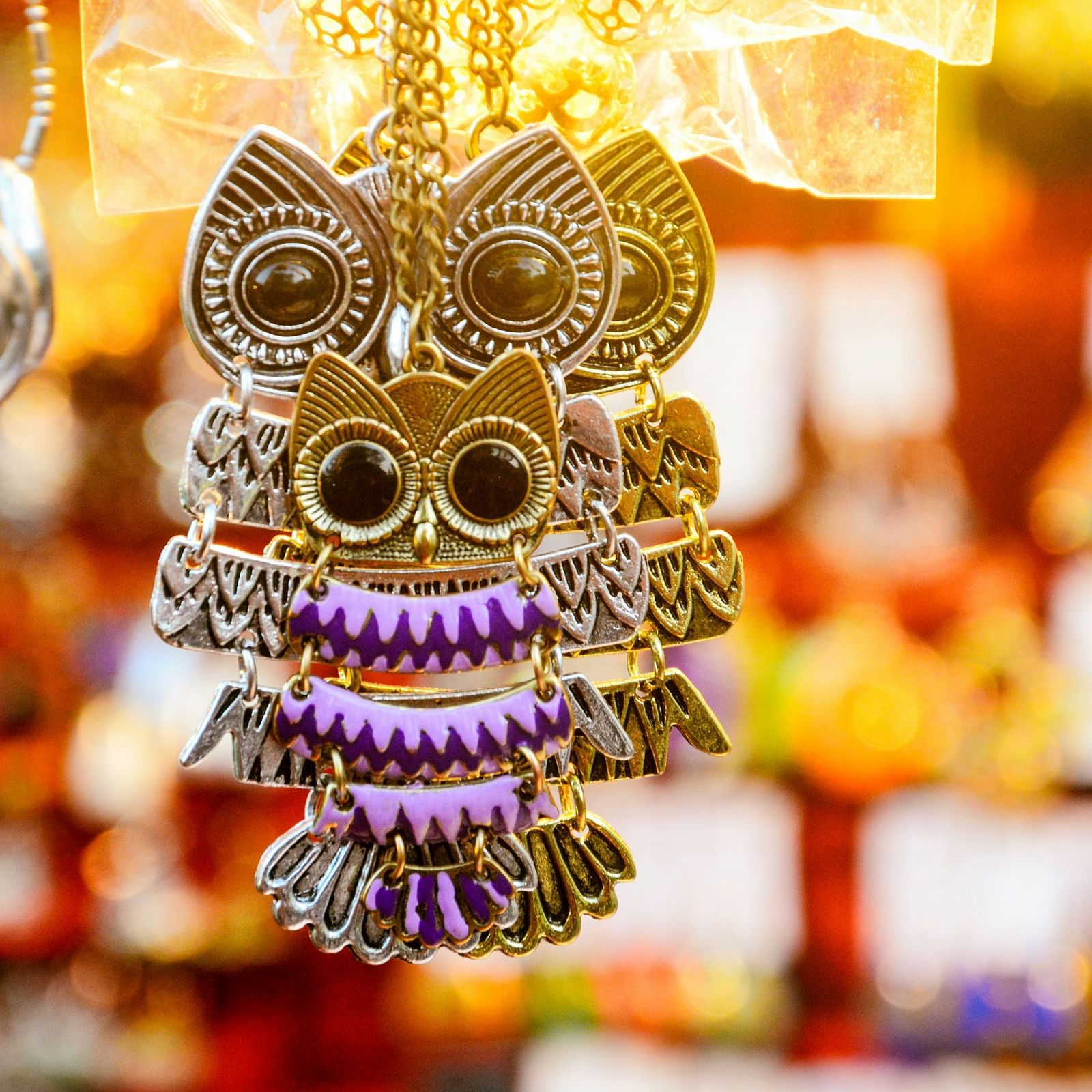 Mexican skull pendant with purple and gold accents for Day of the Dead | Diamond Parks, Pune