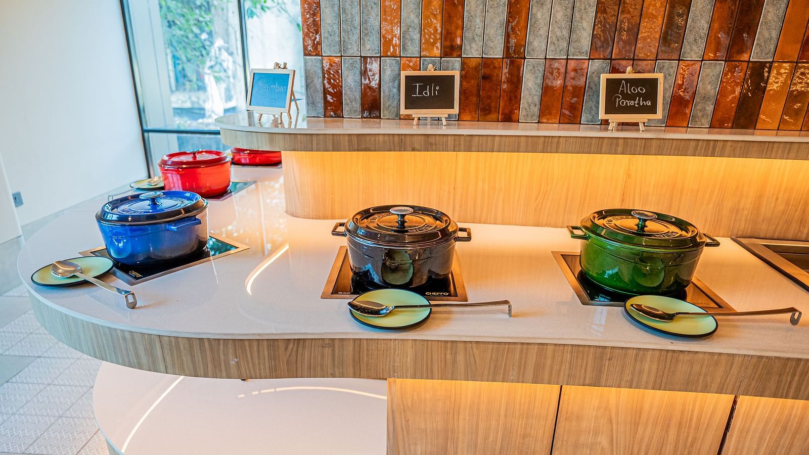  A close-up of the buffet counter, with vessels neatly arranged at Indie Stays Mumbai International Airport.