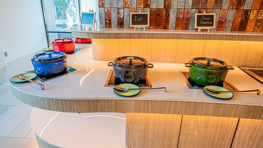  A close-up of the buffet counter, with vessels neatly arranged at Indie Stays Mumbai International Airport.