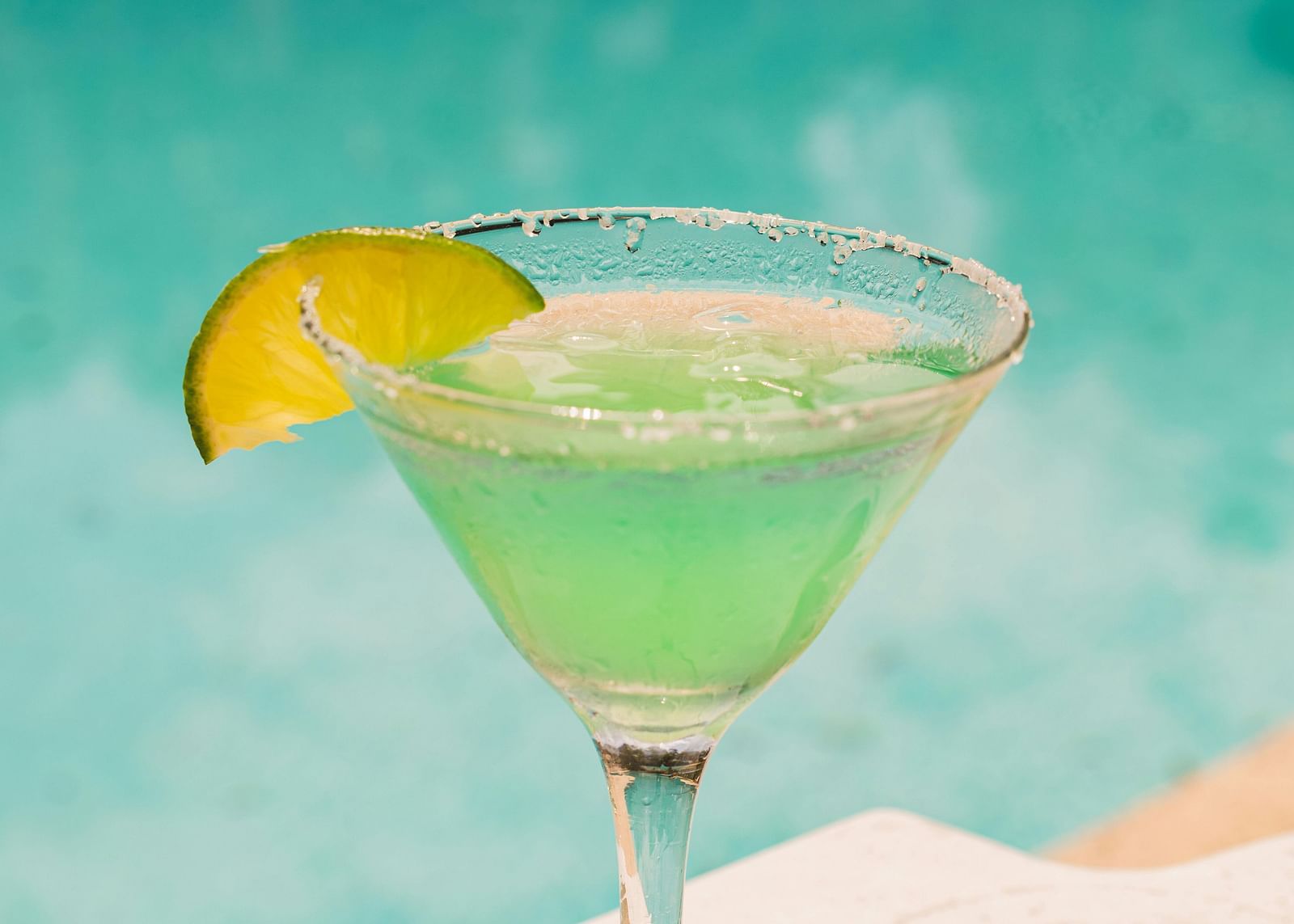 A refreshing lime margarita with a salted rim and lime garnish by a poolside - Hotel 39, Jamaica