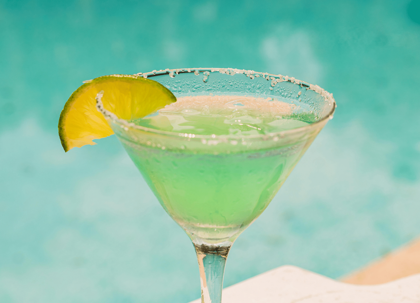 A refreshing lime margarita with a salted rim and lime garnish by a poolside - Hotel 39, Jamaica