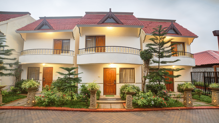 Charming villa-style accommodation surrounded by greenery and paved driveway at Ilara Hotels & Spa, OMR, Chennai