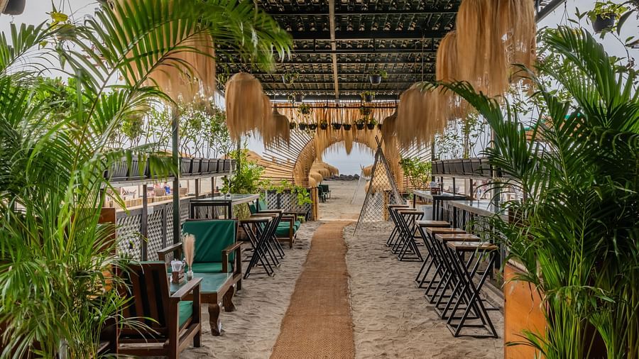 An outdoor dining setting at Love Anna Bar and Restaurant with wooden ambience at Royale Amata - By the Beach.