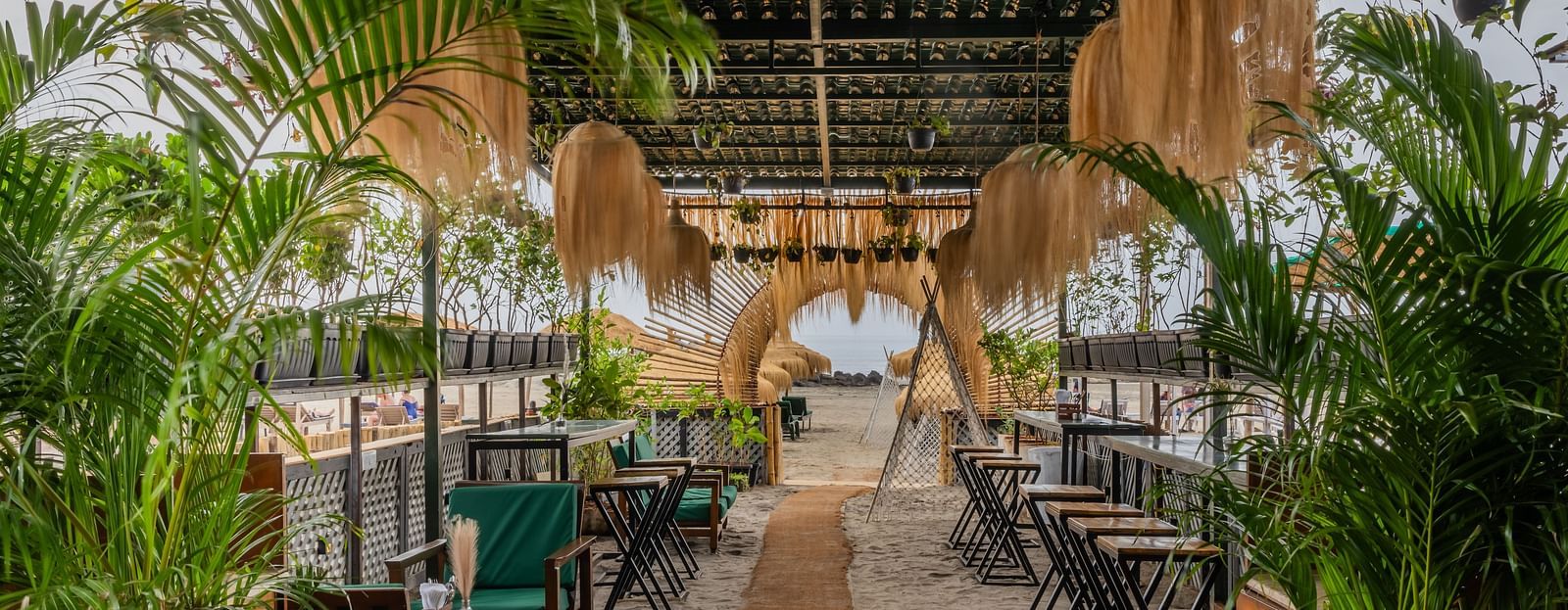 An outdoor dining setting at Love Anna Bar and Restaurant with wooden ambience at Royale Amata - By the Beach.