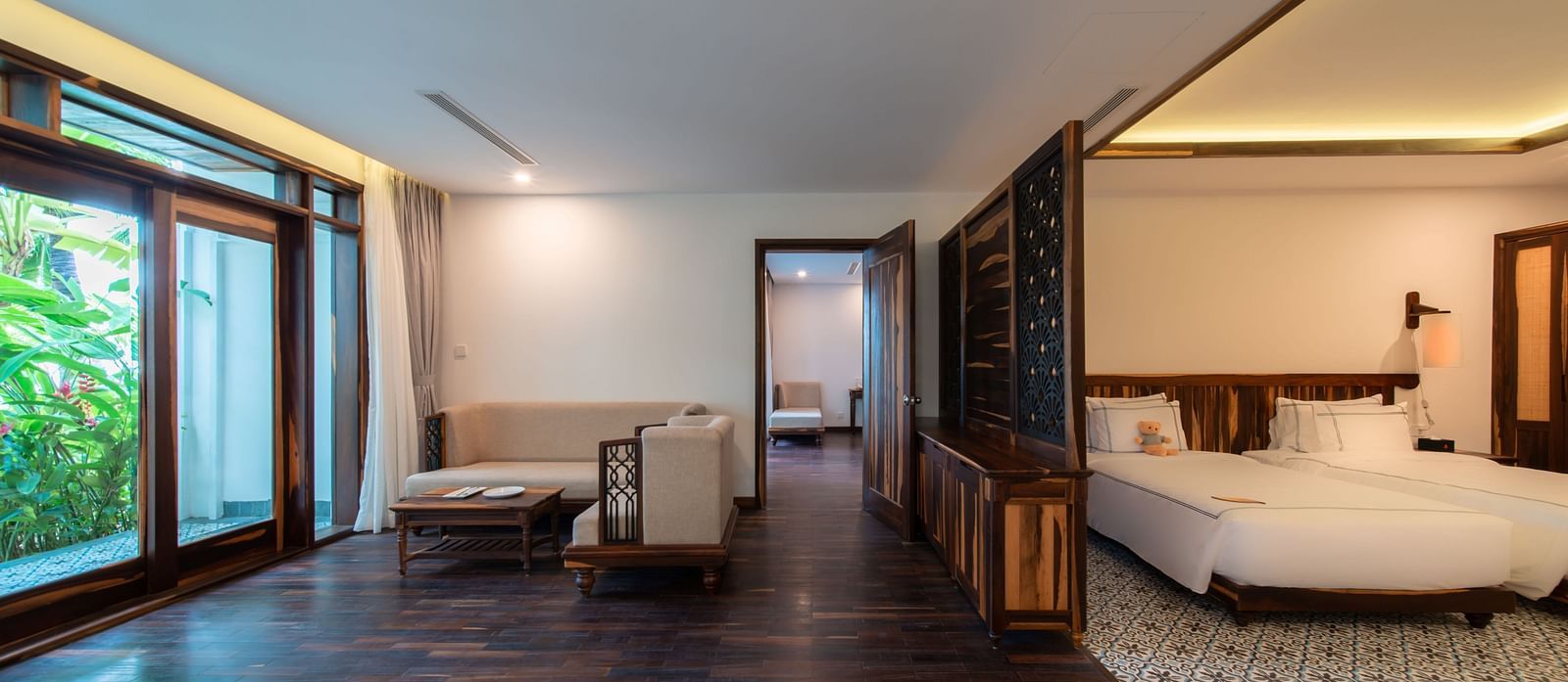 A hotel room with a separate living area near the bedroom and a balcony - Alibu Resort Nha Trang