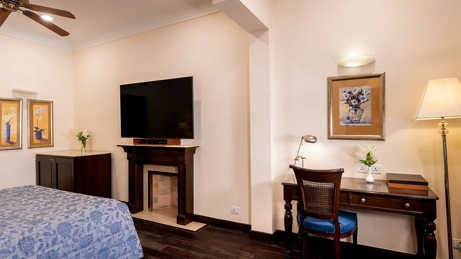 image showing a wall mounted TV along with work desk at the Claridges Room at The Claridges Nabha Residence