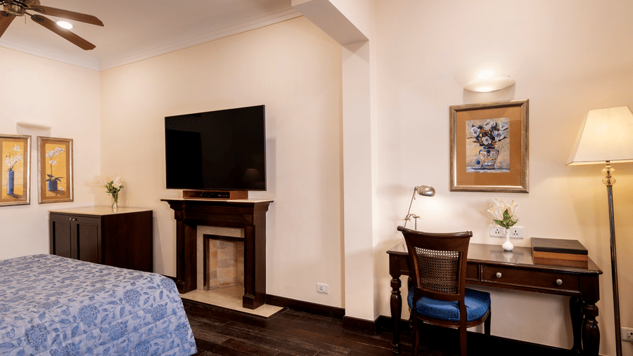 image showing a wall mounted TV along with work desk at the Claridges Room at The Claridges Nabha Residence