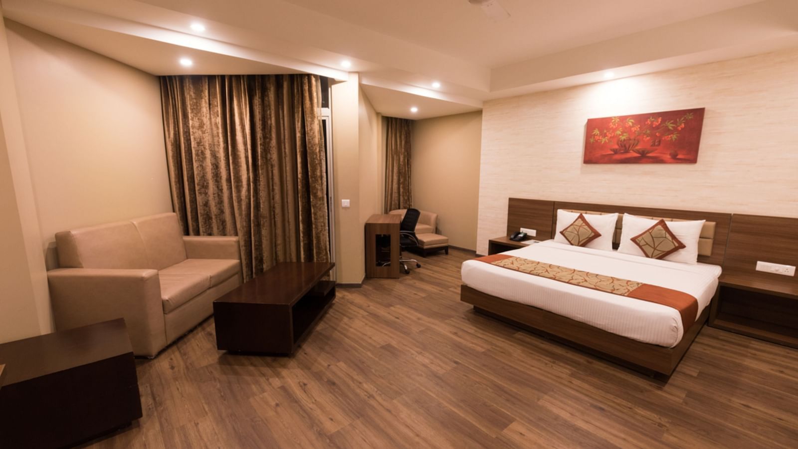 Super Deluxe Rooms with Complimentary Wi-Fi captured with a cosy bed and white linens along with a beige couch - Le ROI Digha Hotel West Bengal1