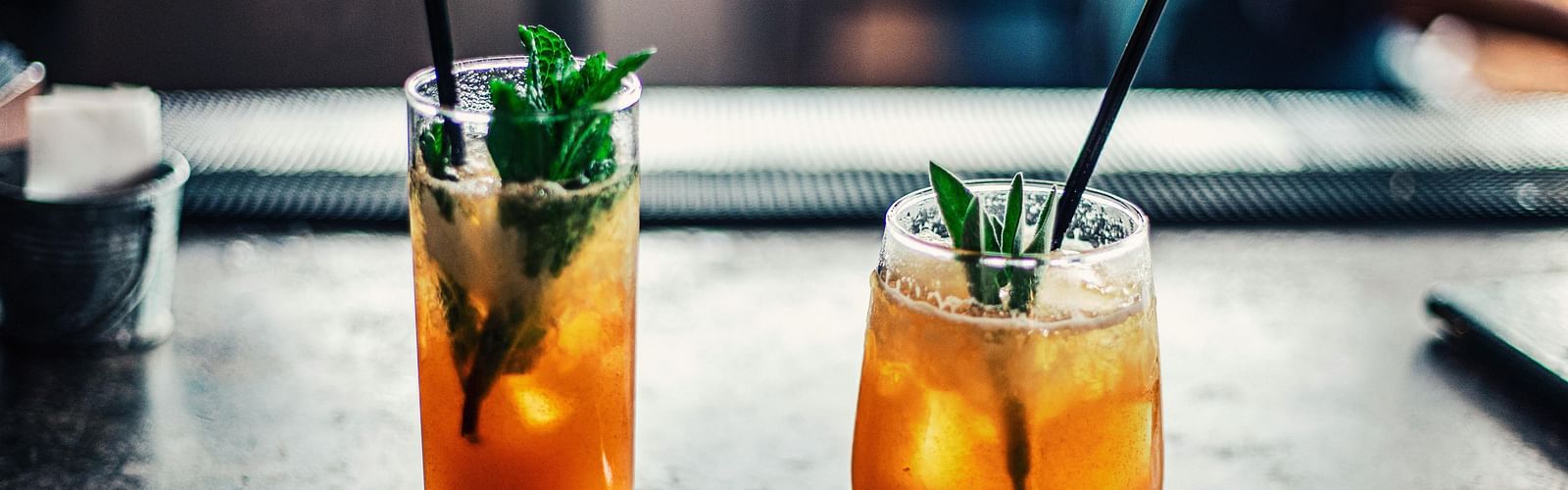 An image of two glasses of cold drinks placed on a tray at the table