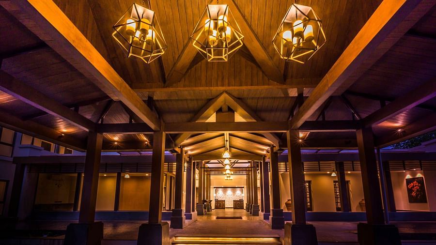 Resort entrance lit with yellow lamps - Rhythm Lonavala