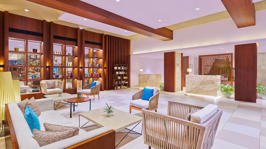 A wide view of lobby with chairs surrounding a coffee table | The Resort