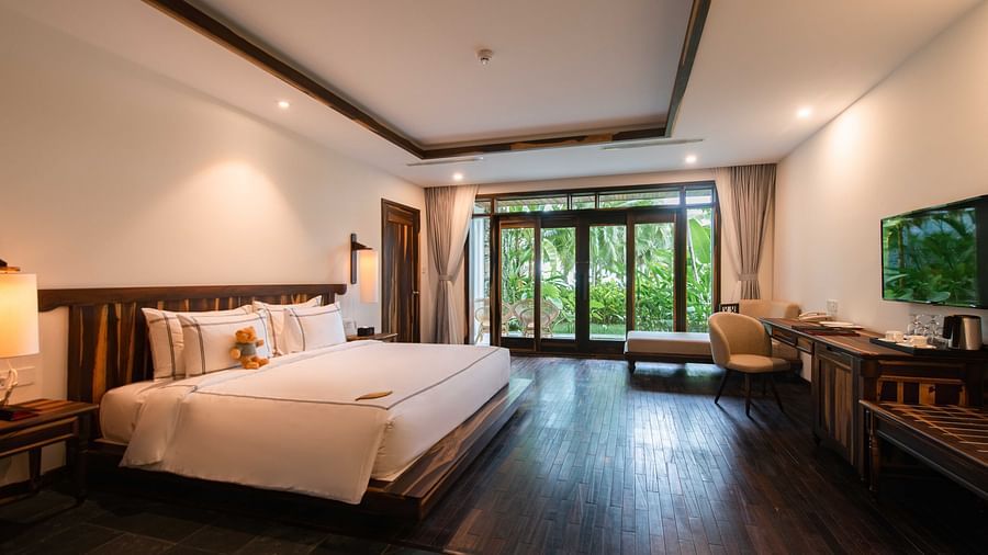 An image of a well furnished bedroom with a balcony - Alibu Resort Nha Thrang