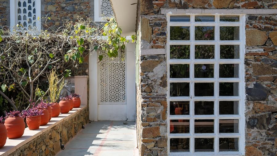 An exterior image of a structure made out of stones - Utsav Camp