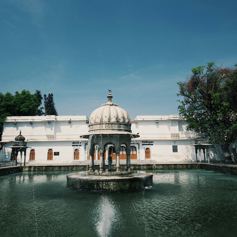 Decorative multi-tier fountain surrounded by lotus ponds at Saheliyon Ki Bari in Udaipur