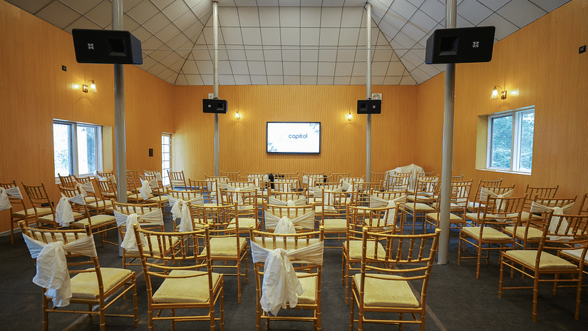 Seating arrangements with a tv in the background at The Carp, Capitol Village Resort, Madikeri