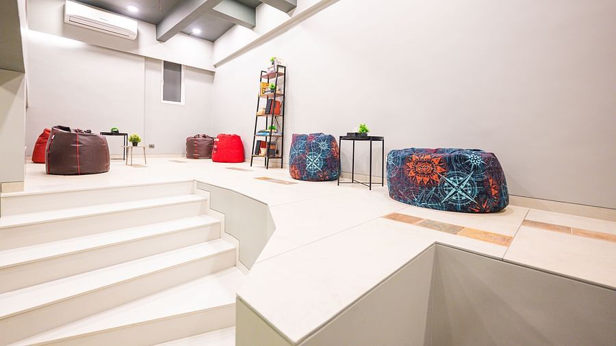 A seating area next to a staircase at Indie Stays, Chembur.
