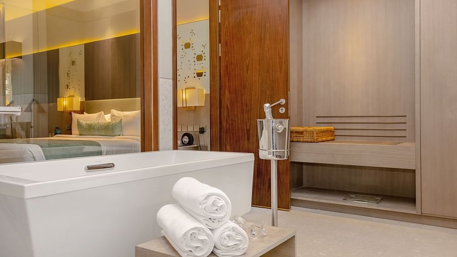 A spacious bathroom with a luxurious bathtub at Neelkanth Sarovar Premiere Lusaka