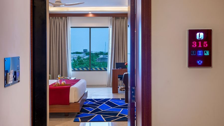 Open-plan room view showing the bed, window seating, and welcoming decor - Lords Eco Inn Shapar Rajkot