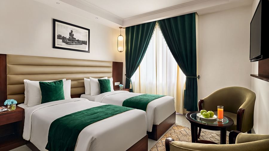 An executive room with twin bed placed in front of a wall-mounted television - Deventure Sarovar Portico, Patel Nagar