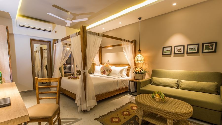 A room at Swosti Chilika Resort with a double bed and sofa seating