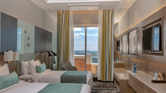 A modern room with a comfortable seating area and natural light at Neelkanth Sarovar Premiere Lusaka