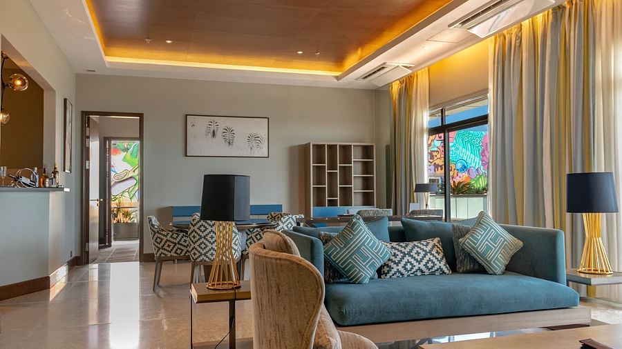 A luxurious penthouse living area with stylish furniture and warm lighting at NeelkaA luxurious penthouse living area with stylish furniture and warm lighting at Neelkanth Sarovar Premiere Lusaka