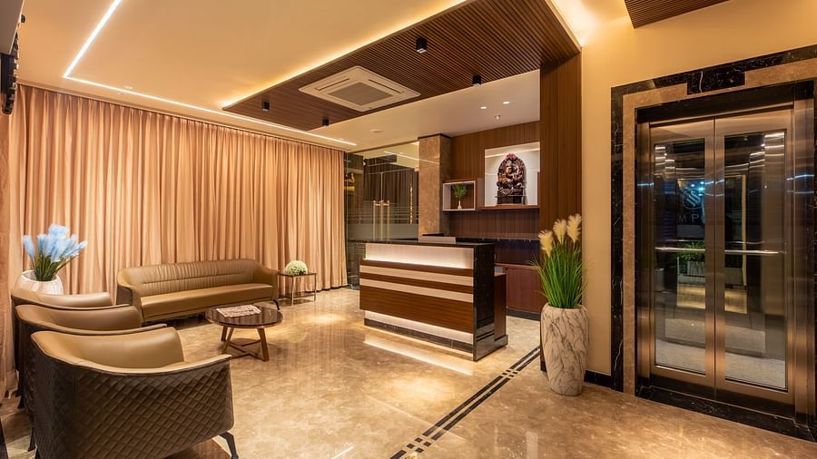 An image showcasing the reception area, featuring sofas and a table at M Pro Palace.