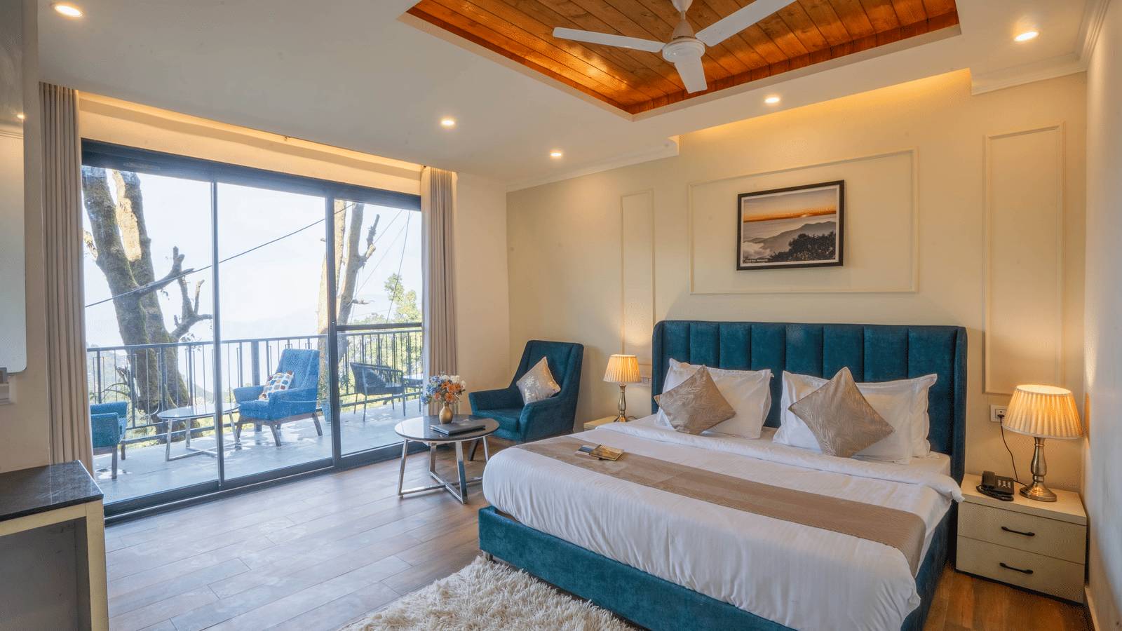 Full-view shot of the Super Deluxe Room With Shared Balcony & Valley View showcasing a double bed and a balcony with with huge french windows at Perfectstayz Premium Westend Mall Road, Mussoorie.