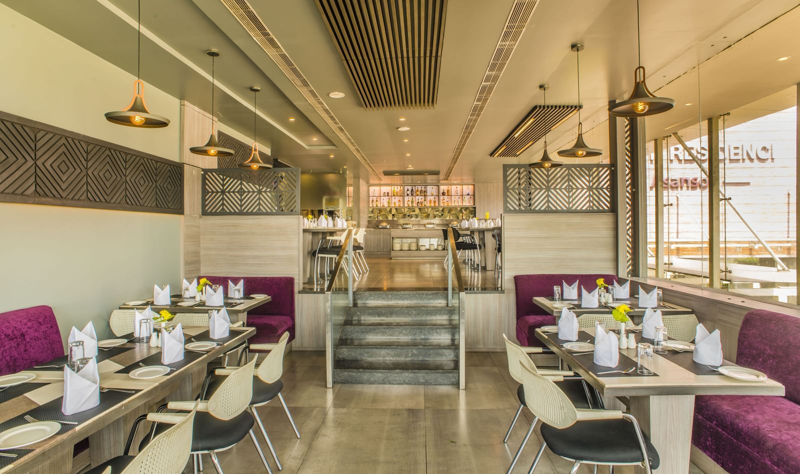 A restaurant dining area with tables and chairs at The Citi Residenci Hotel, Asansol.
