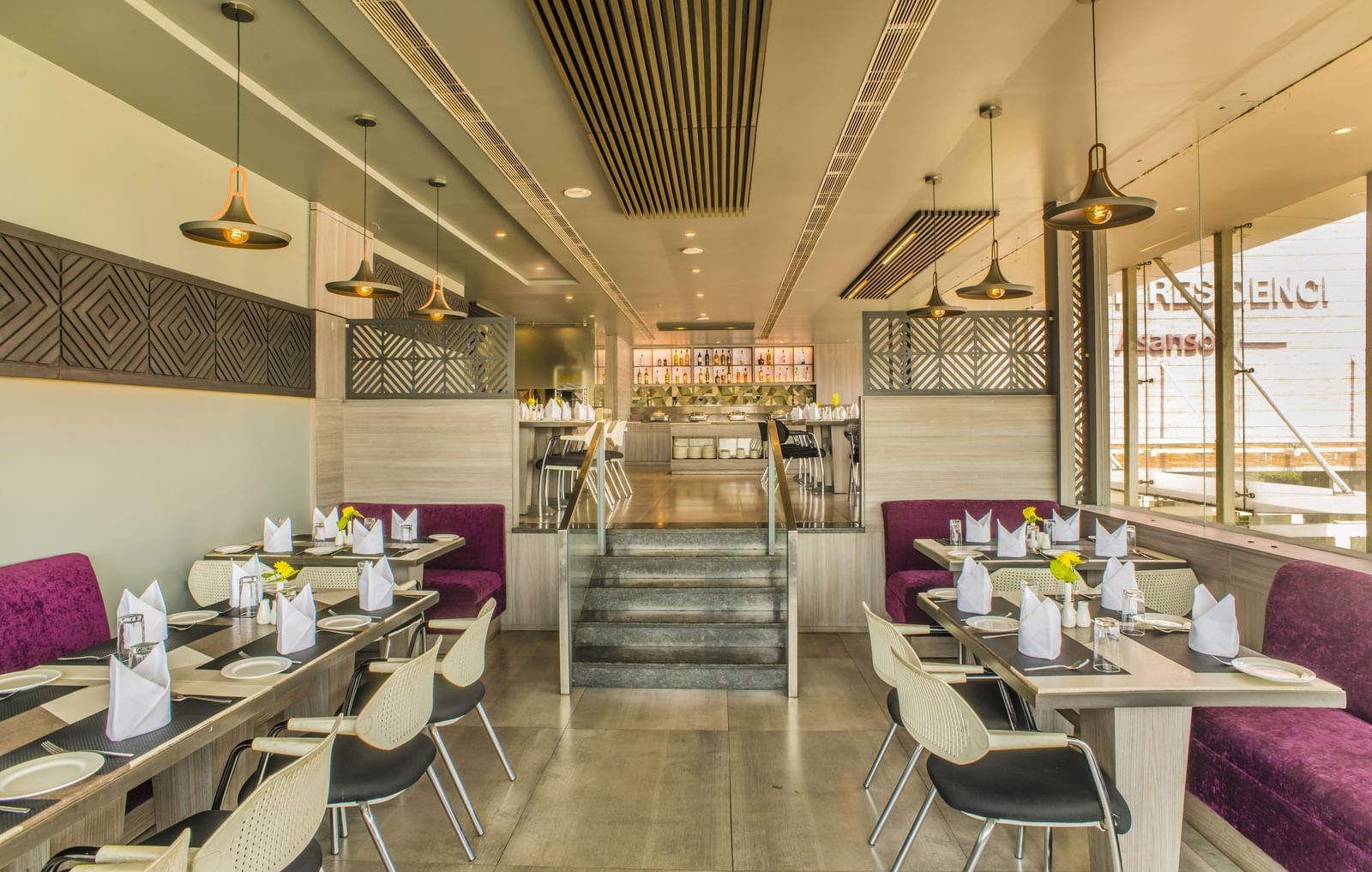 A restaurant dining area with tables and chairs at The Citi Residenci Hotel, Asansol.