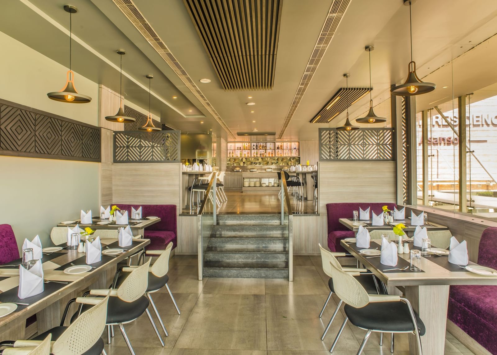 A restaurant dining area with tables and chairs at The Citi Residenci Hotel, Asansol.