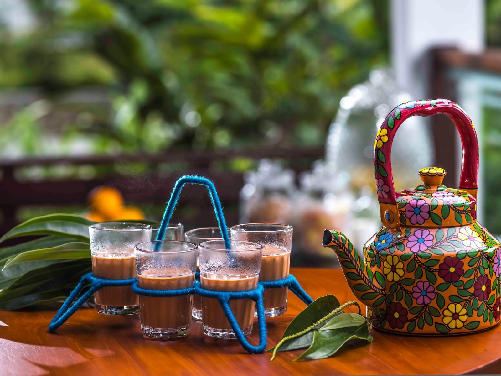 A shot of tea cups and a kettle kept at the table.