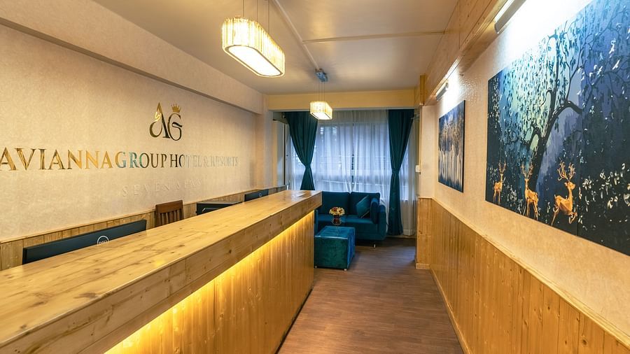 Reception with wooden desk and long hall way at Avianna Seven Seas, Darjeeling