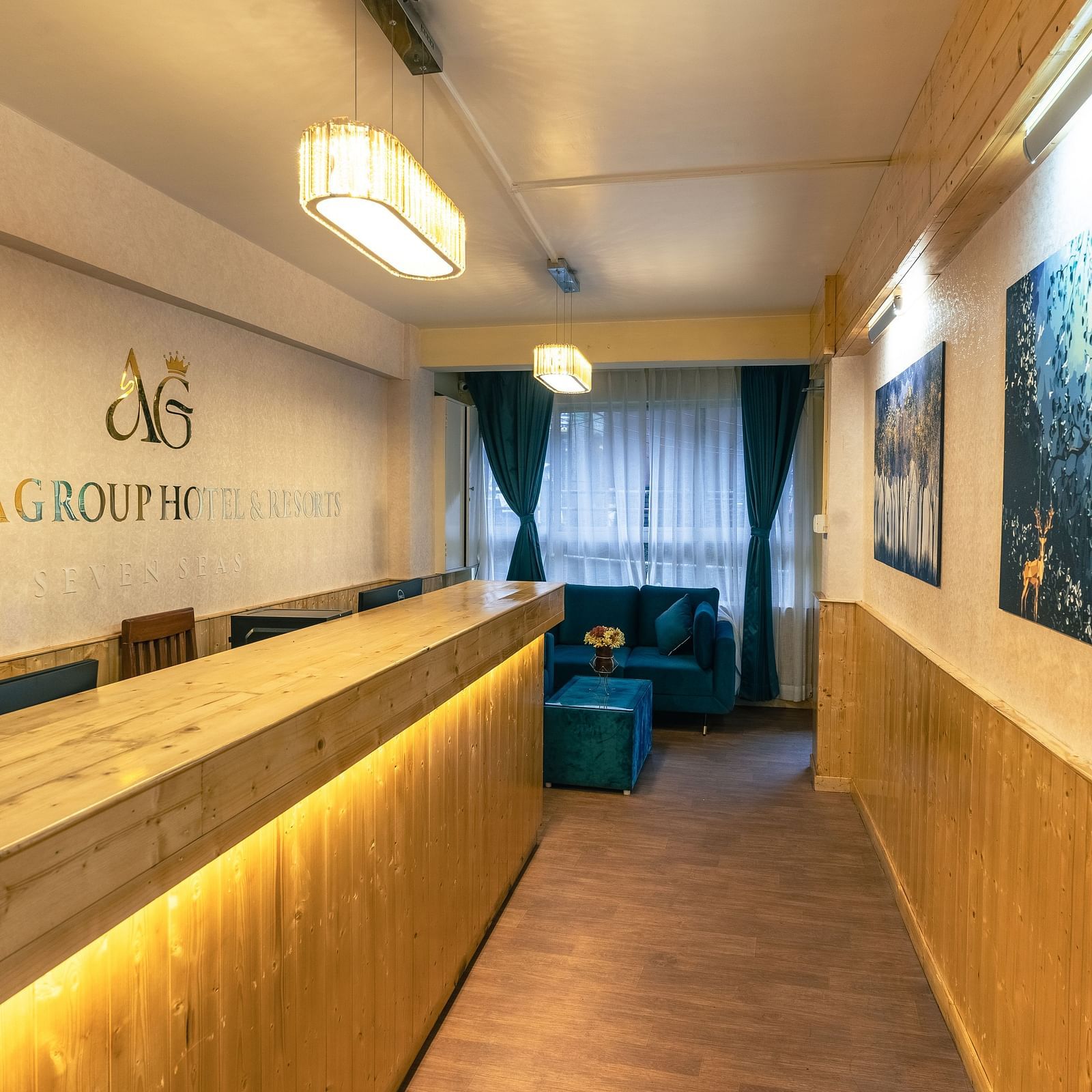 Reception area with warm welcoming lighting and wooden furnitures at Avianna Seven Seas, Darjeeling3