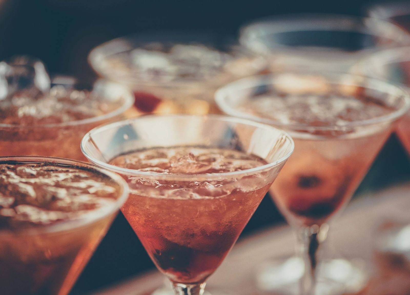 Several glasses filled with various colorful cocktails are arranged closely together, ready to be served | Altamont Court, Jamaica