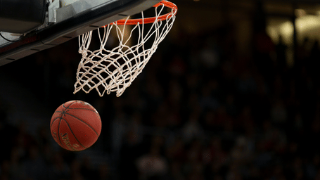 A basketball falls directly through the net during a match.