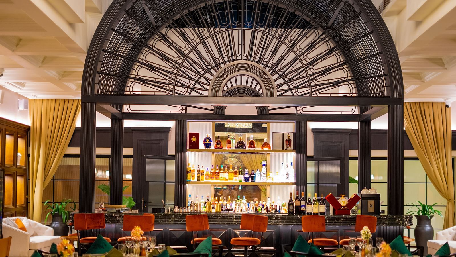 Aria Restaurant at KertelSuites, showcasing a stylish bar setup with neatly arranged tables and chairs