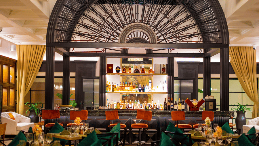 Aria Restaurant at KertelSuites, showcasing a stylish bar setup with neatly arranged tables and chairs