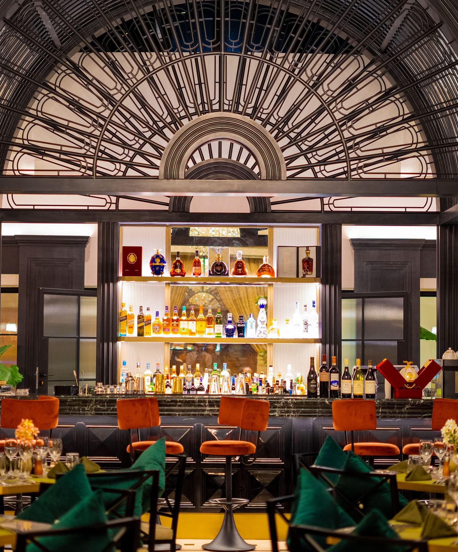 Aria Restaurant at KertelSuites, showcasing a stylish bar setup with neatly arranged tables and chairs