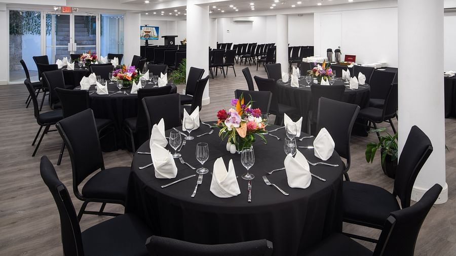 A conference room with round tables, comfortable chairs and ambient lighting - S Hotel Montego Bay, Jamaica