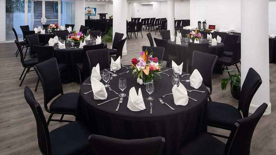 A conference room with round tables, comfortable chairs and ambient lighting - S Hotel Montego Bay, Jamaica