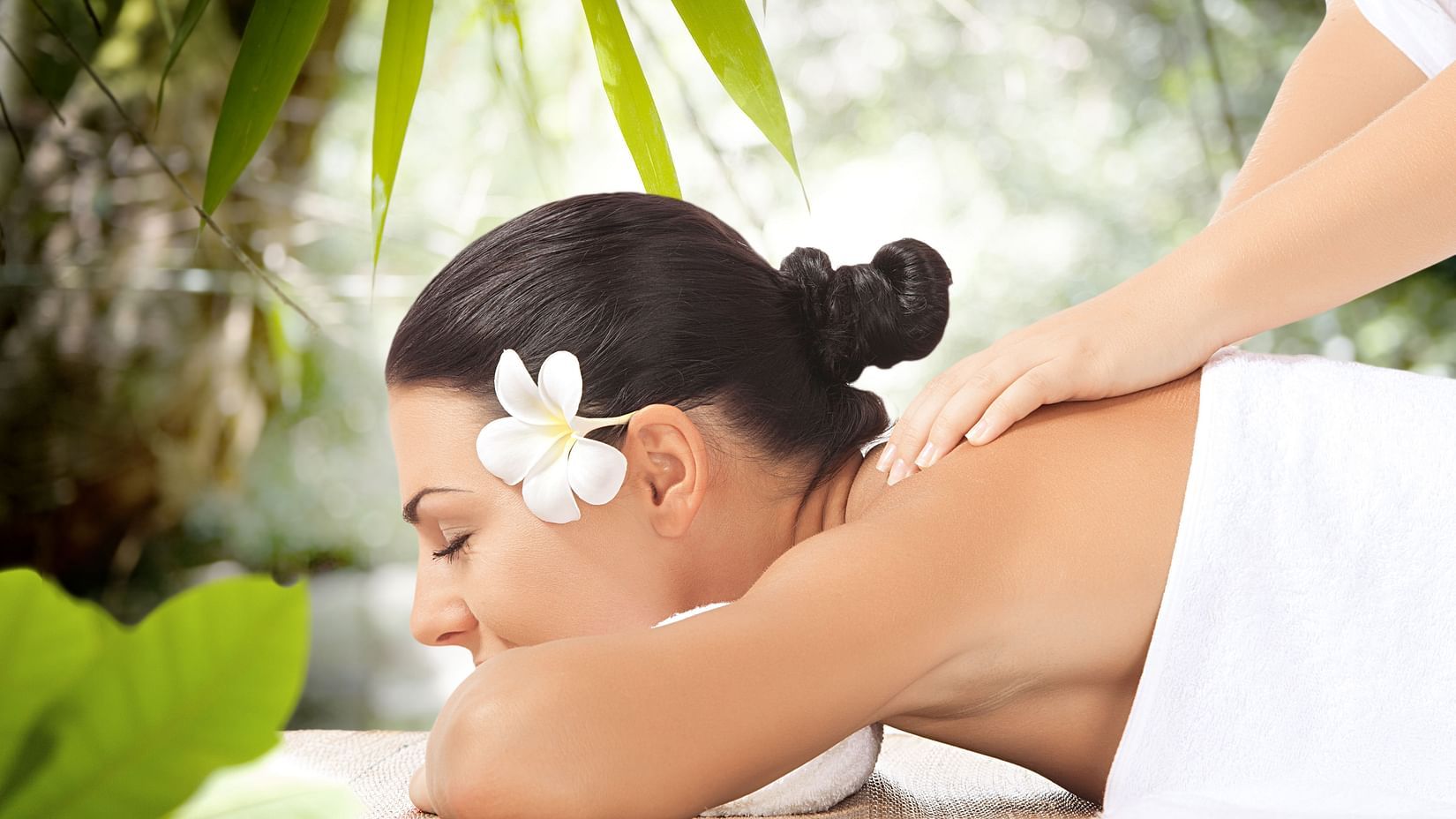 Side view of a woman getting a back rub
