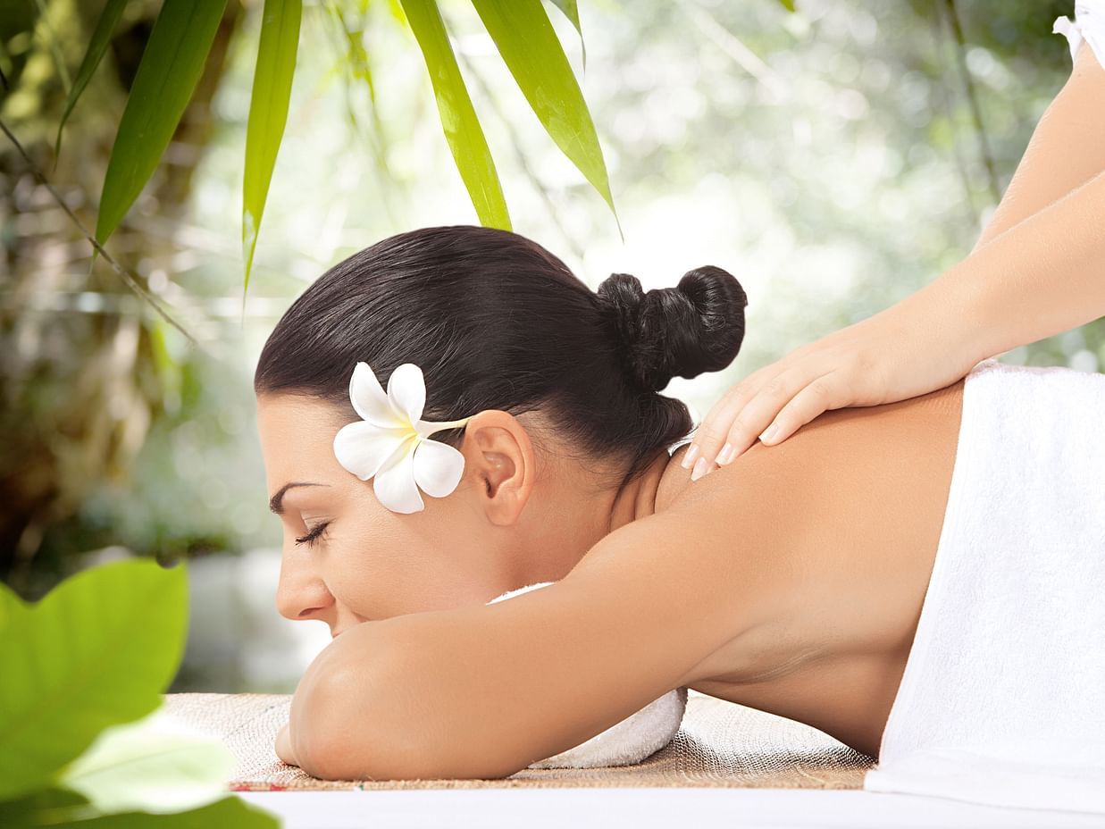Side view of a woman getting a back rub