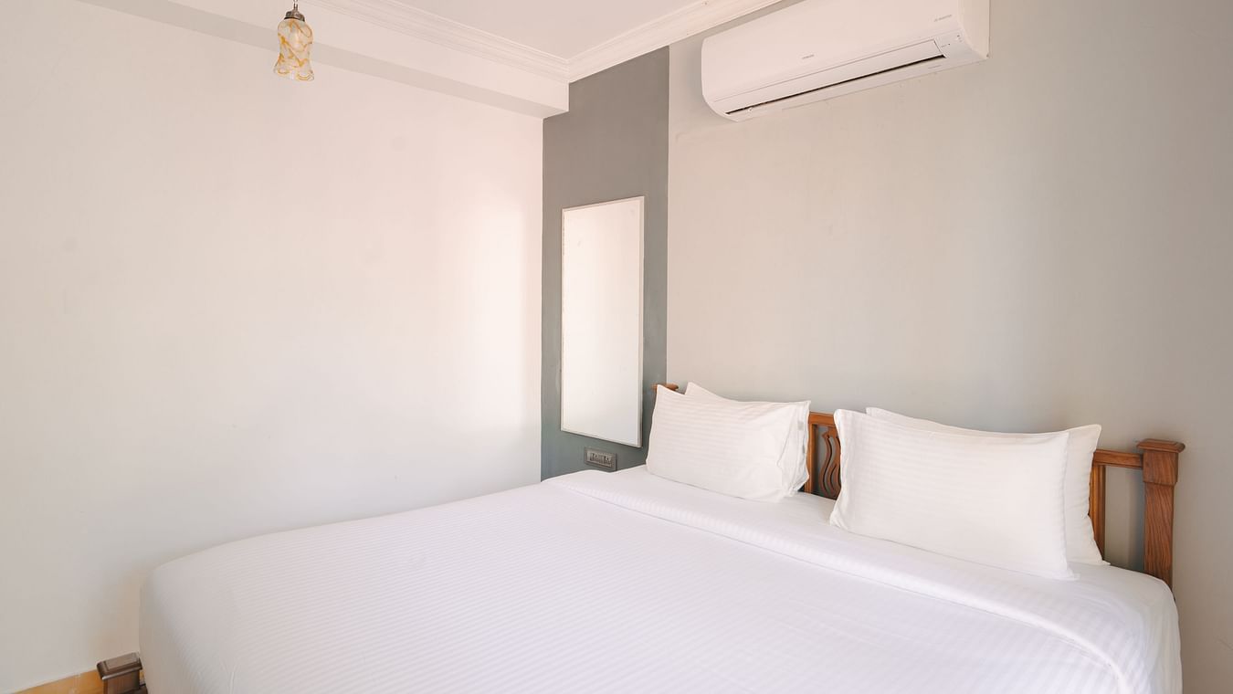 Minimalist bedroom design with soft lighting and comfortable bedding at the Two BHK apartment in Richmonde Ananta Elite, Goa.