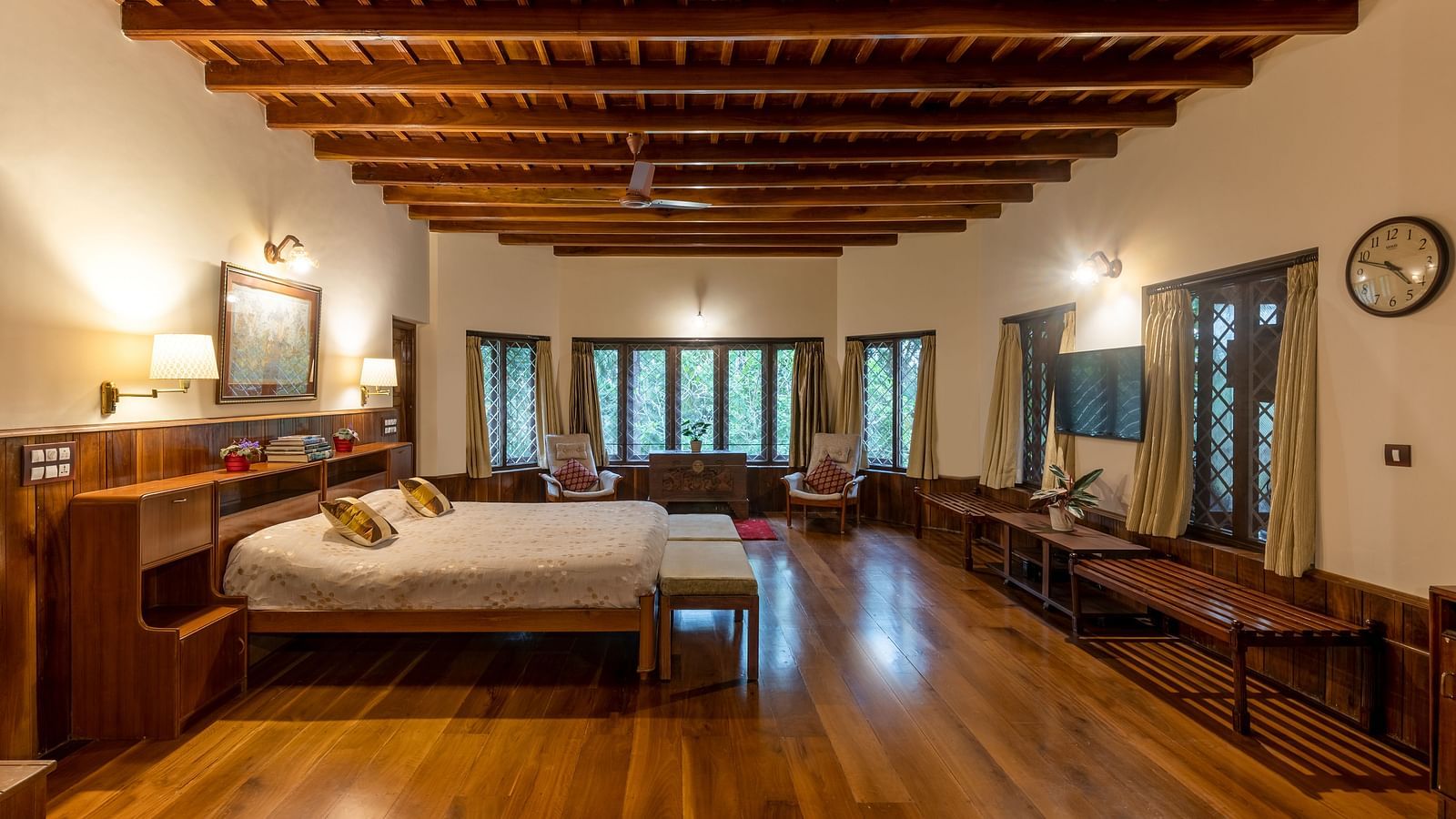 Spacious room with twin beds, wooden floors, and a distinctive wooden ceiling - BluSalzz Collection - Tranquil Resort, Wayanad