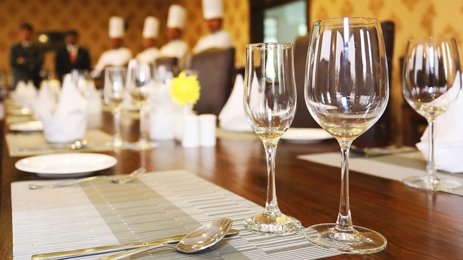 A restaurant image  featuring chefs in the background and wine glasses - Clarks Safari, Ranthambore