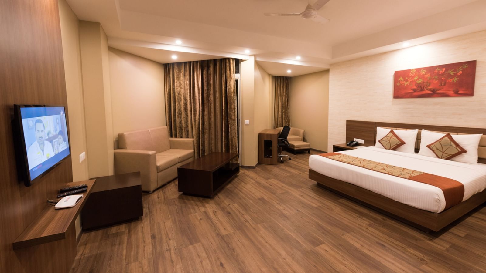 Super Deluxe Rooms with Complimentary Wi-Fi captured with a cosy bed and white linens along with a beige couch - Le ROI Digha Hotel West Bengal2